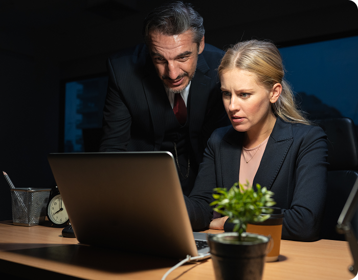 colleagues-working-laptop-office-desk